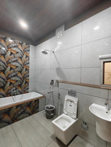 a bathroom with a toilet and a sink at Linn View Home Stay Munnar in Munnar