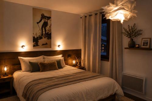 a bedroom with a large bed and a window at Chalet Le Quartz in Val Thorens