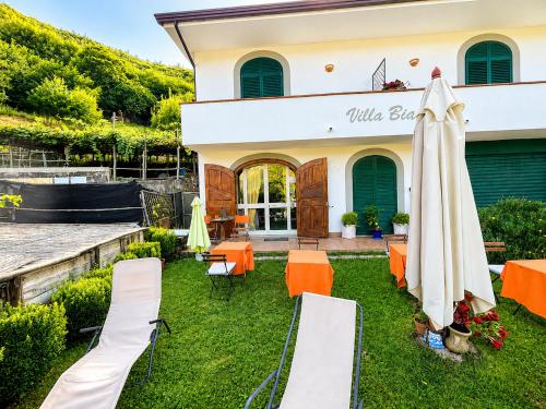 a patio with an umbrella in front of a building at Villa Bianca in Tramonti