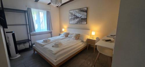 a small bedroom with a bed and a sink at Hotel Surselva in Chur