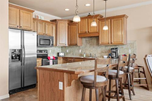a kitchen with wooden cabinets and stainless steel appliances at Smirnoff Pointe Lakefront in Hollister