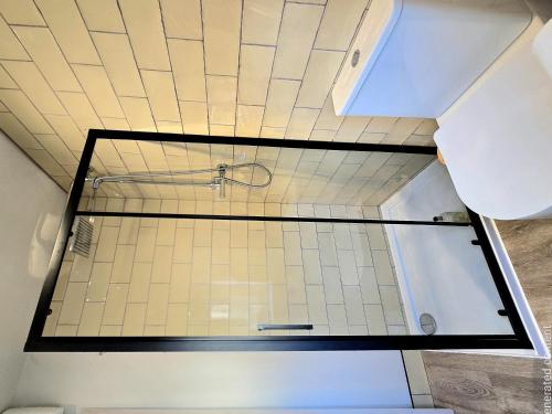 a shower in a bathroom with a tile ceiling at Studio 3 - Stylish apartment central to hospital and racecourse in Cheltenham