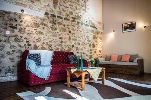a living room with a couch and a table at Jason's Stone House in Ágios Matthaíos