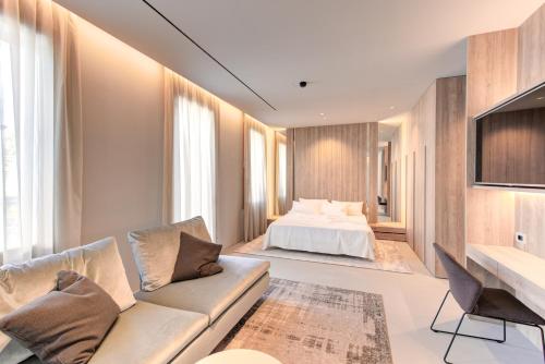 a living room with a bed and a couch at Villa Italia in Cesenatico