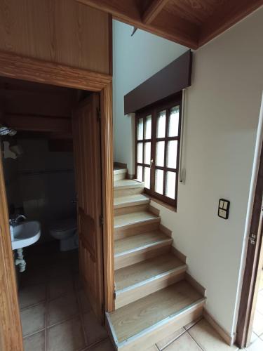a stairway leading to a room with a window at La casuca in Noja