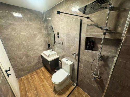 a bathroom with a shower and a toilet and a sink at Fethibey Otel in Bartın