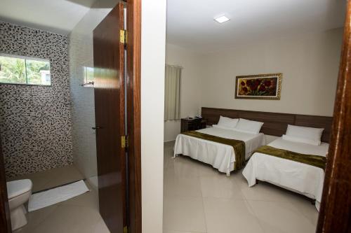 Ένα ή περισσότερα κρεβάτια σε δωμάτιο στο Recanto Hotel Clube