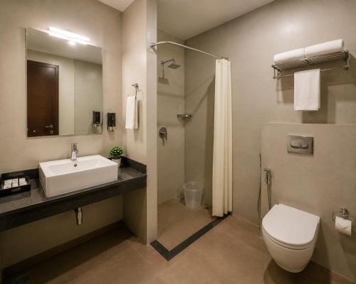 a bathroom with a sink and a toilet and a shower at Hotel S-mart In Delhi Airport & Free Airport Pickup in New Delhi