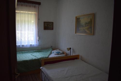 a bedroom with two beds and a window at Tiha Varoš in Varoš