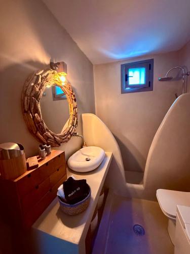 a bathroom with a toilet and a mirror at Noema Seaside in Dhaskalión