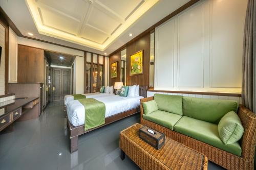 a bedroom with a bed and a green couch at At Tree Hotel Thaphae Gate Chiangmai in Chiang Mai