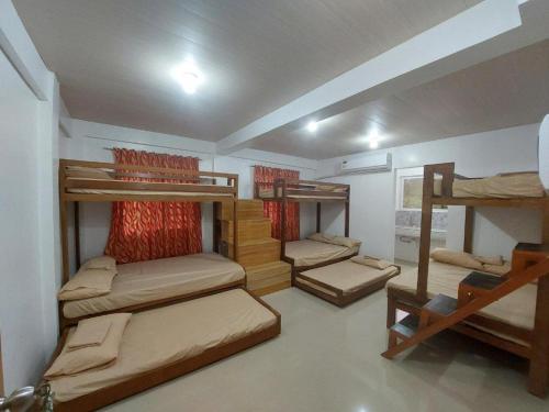 a room with four bunk beds in it at CMJ Private Resort in Banaba Cerca