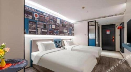a bedroom with two beds and a wall with signs at 7 Days Inn Baoding Railway Station in Baoding