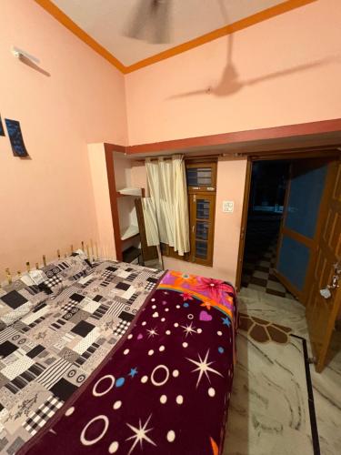 a bedroom with a large bed in a room at Arav Homestay in Rishīkesh