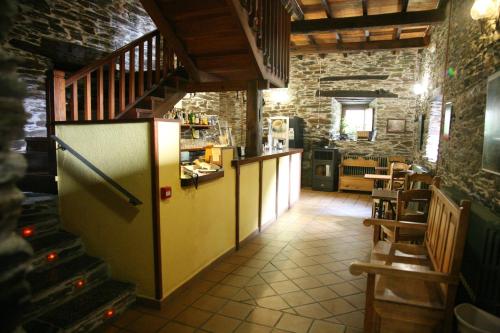 a kitchen with a refrigerator and a staircase in a room at Casa Grande da Ferreria de Rugando in Rugando
