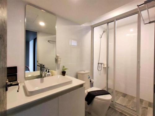 a bathroom with a sink and a toilet and a shower at Silom Studios in Bangkok