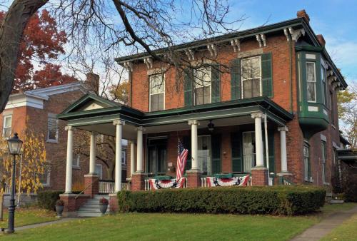 a red brick house with an american flag on it at The Gridley Inn B&B in Waterloo