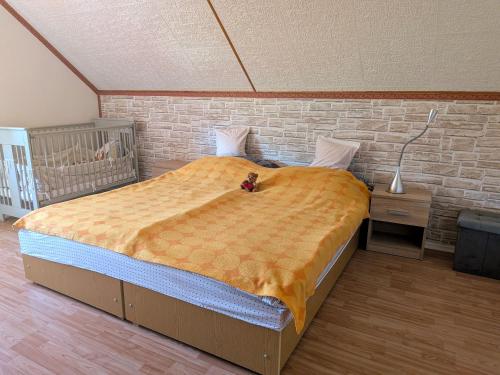 a bedroom with a large bed with a teddy bear on it at Hoffman Apartment in Balatonszárszó