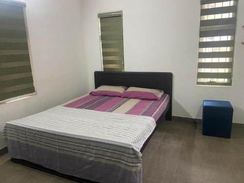 a bed in a room with two pillows on it at SOLITUDE Riverside Holiday Home in Vallikunnu