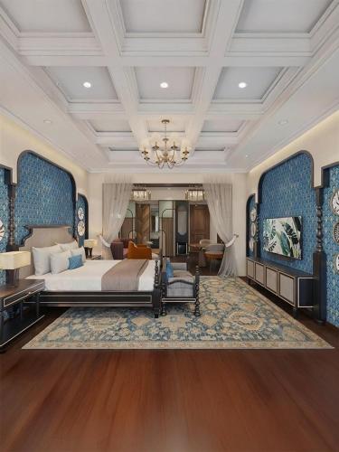 a large bedroom with a large bed and a chandelier at Hotel Arif Castle, Nainital in Nainital