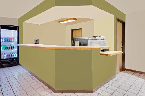 a kitchen with a counter with a microwave at Super 8 by Wyndham Denver Central in Denver