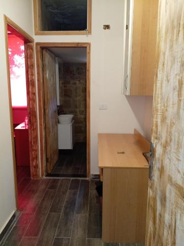 a kitchen with a sink and a toilet in a room at Khalle lodge in Dayr al Qamar