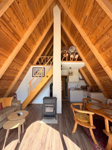 a living room with a vaulted ceiling with wooden ceilings at Vila Caričić Žabljak in Žabljak