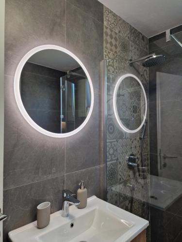 a bathroom with a sink and a mirror at Miljana in Vukovar