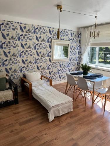 a living room with a bed and a table and chairs at Ottenson Saaremaa apartment in Salme