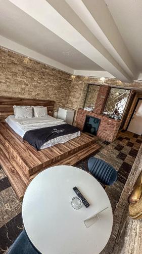 a bedroom with a bed and a white table at Panorama Rezidans Kayseri in Kayseri