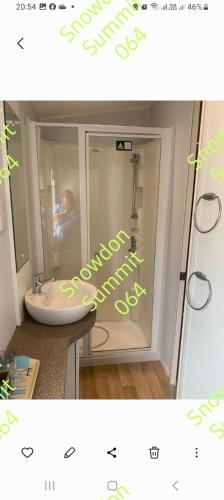a picture of a bathroom with a sink and a mirror at Snowdon summit 064 in Barmouth