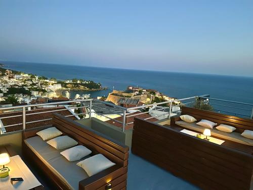 a balcony with pillows and a view of the ocean at Apartments Tati in Ulcinj