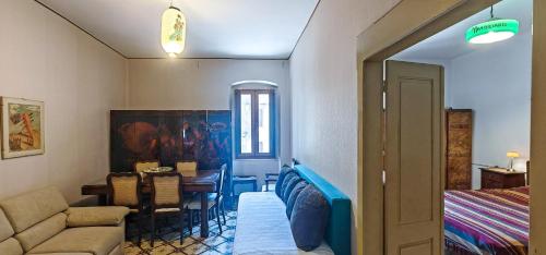 a living room with a couch and a dining room at Nautilus in Cuglieri