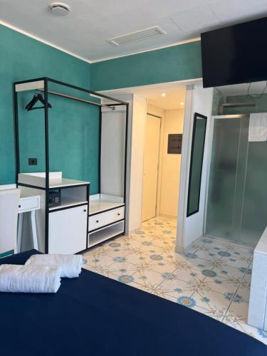 a bathroom with a sink and a large mirror at Hotel Ancora in Pontecagnano
