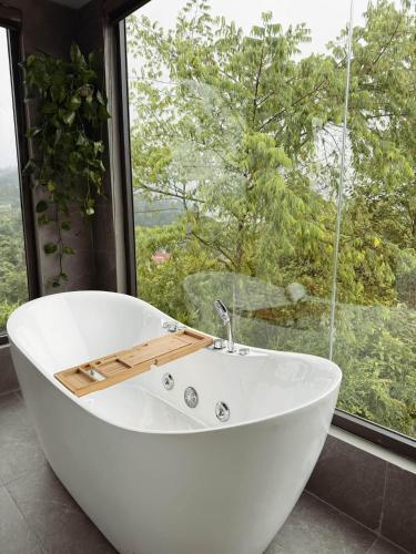 a white bath tub in front of a window at Sun Hill Villa in Lao Cai