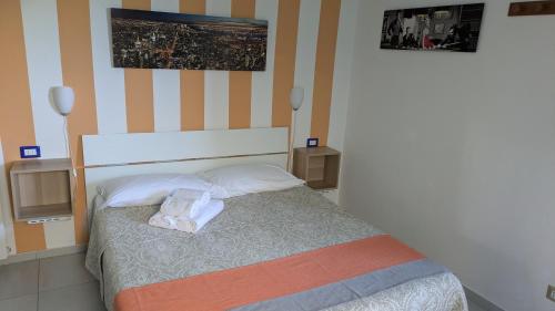 a bedroom with a bed with two towels on it at Guesthouse Sofia in Stresa