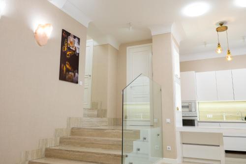 a staircase in a home with a glass case at Maxim Pasha Hotel in Chişinău