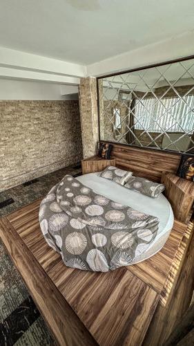 a bedroom with a large bed with a wooden frame at Panorama Rezidans Kayseri in Kayseri
