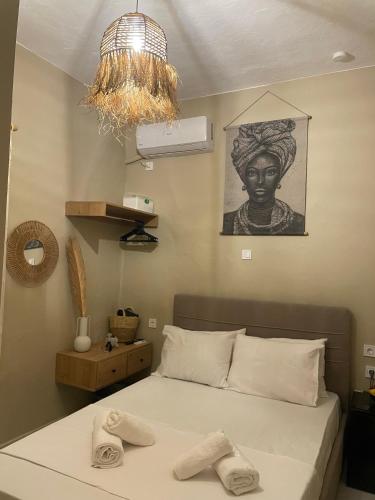 a bedroom with a bed with two towels on it at Boho Nest in Mytilene