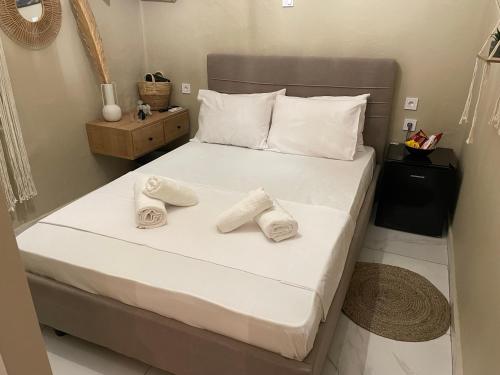 a bedroom with a bed with two towels on it at Boho Nest in Mytilene