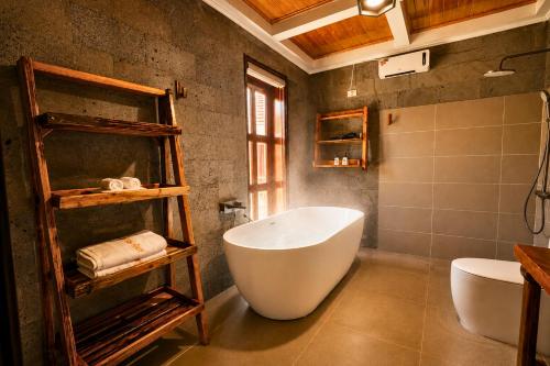 a bathroom with a large tub and a sink at Cloud Paradise Resort in Lao Cai