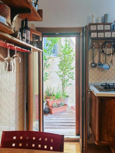 a kitchen with a door open to a patio at Nautilus in Cuglieri