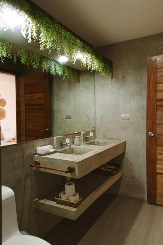 a bathroom with a sink and a mirror at SAMADHI Resort & Hydrospa Panglao in Panglao Island