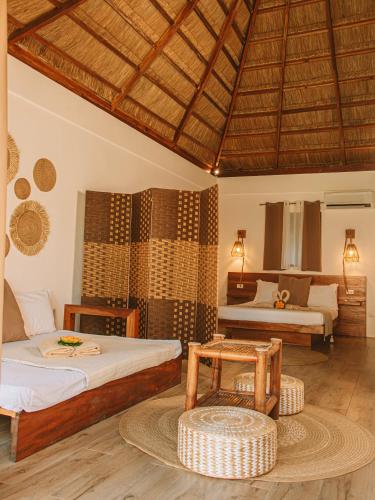 a bedroom with two beds and a table at SAMADHI Resort & Hydrospa Panglao in Panglao Island