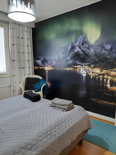 a bedroom with a bed with a painting on the wall at Apartment Kivistö, 2 km from centrum, free wifi and parking, no smoking, non-allergenic in Jyväskylä
