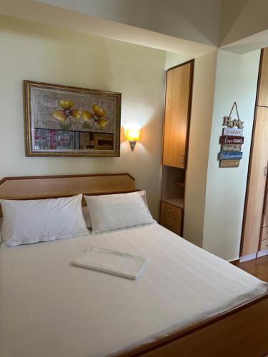 a white bed with a tray on top of it at Apartment Sea View in Shëngjin