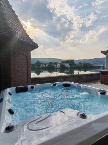 a hot tub with a view of the water at L'Escale du Rhône de 1 à 8 personnes in Saint-Vallier