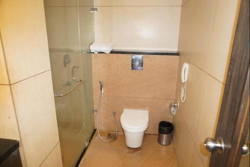 a small bathroom with a toilet and a shower at Hotel Las Vegas in Jaipur