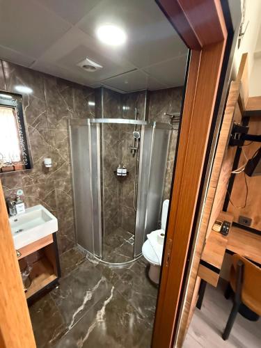 a bathroom with a shower and a toilet and a sink at Vizyon Hotel Center in Istanbul