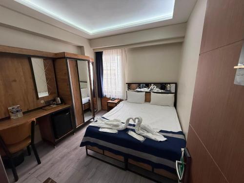 a bedroom with a bed with towels on it at Vizyon Hotel Center in Istanbul